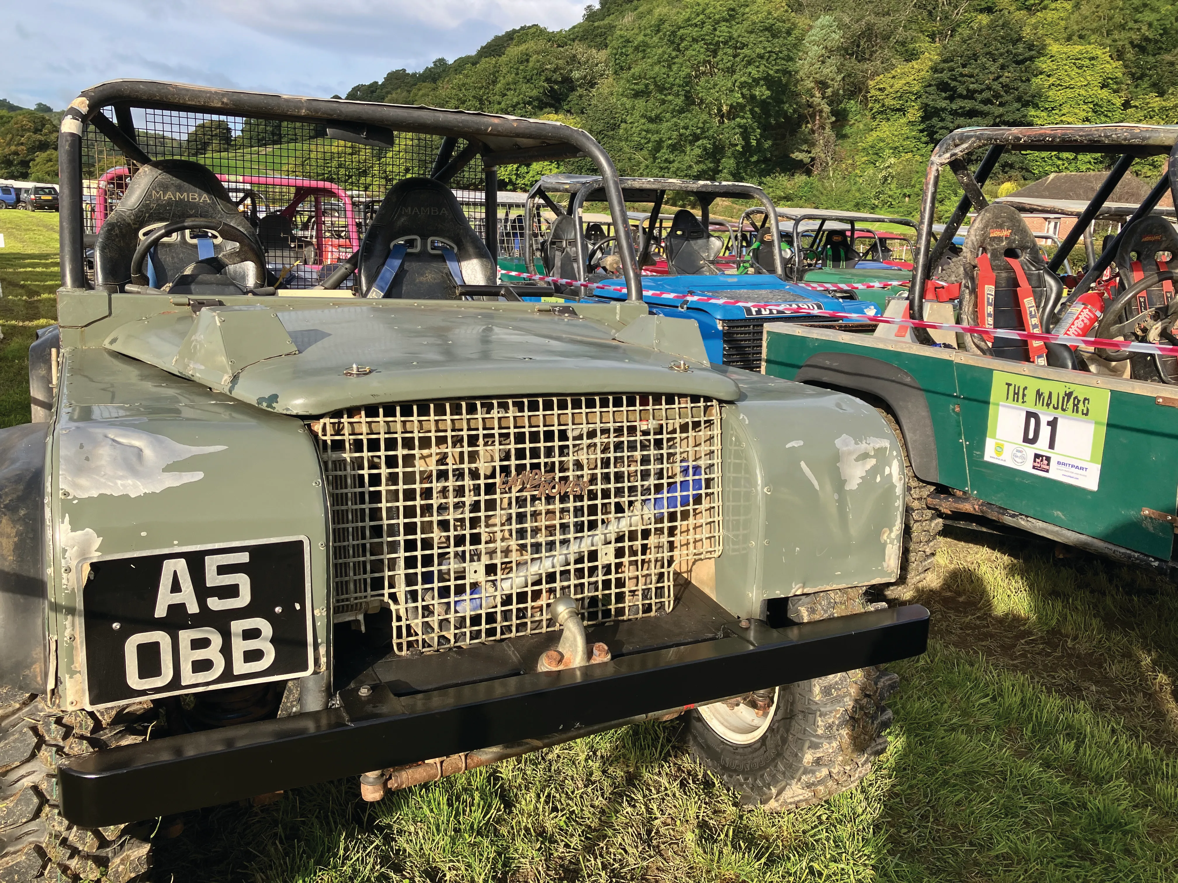 A Land Rover working through a wooded section